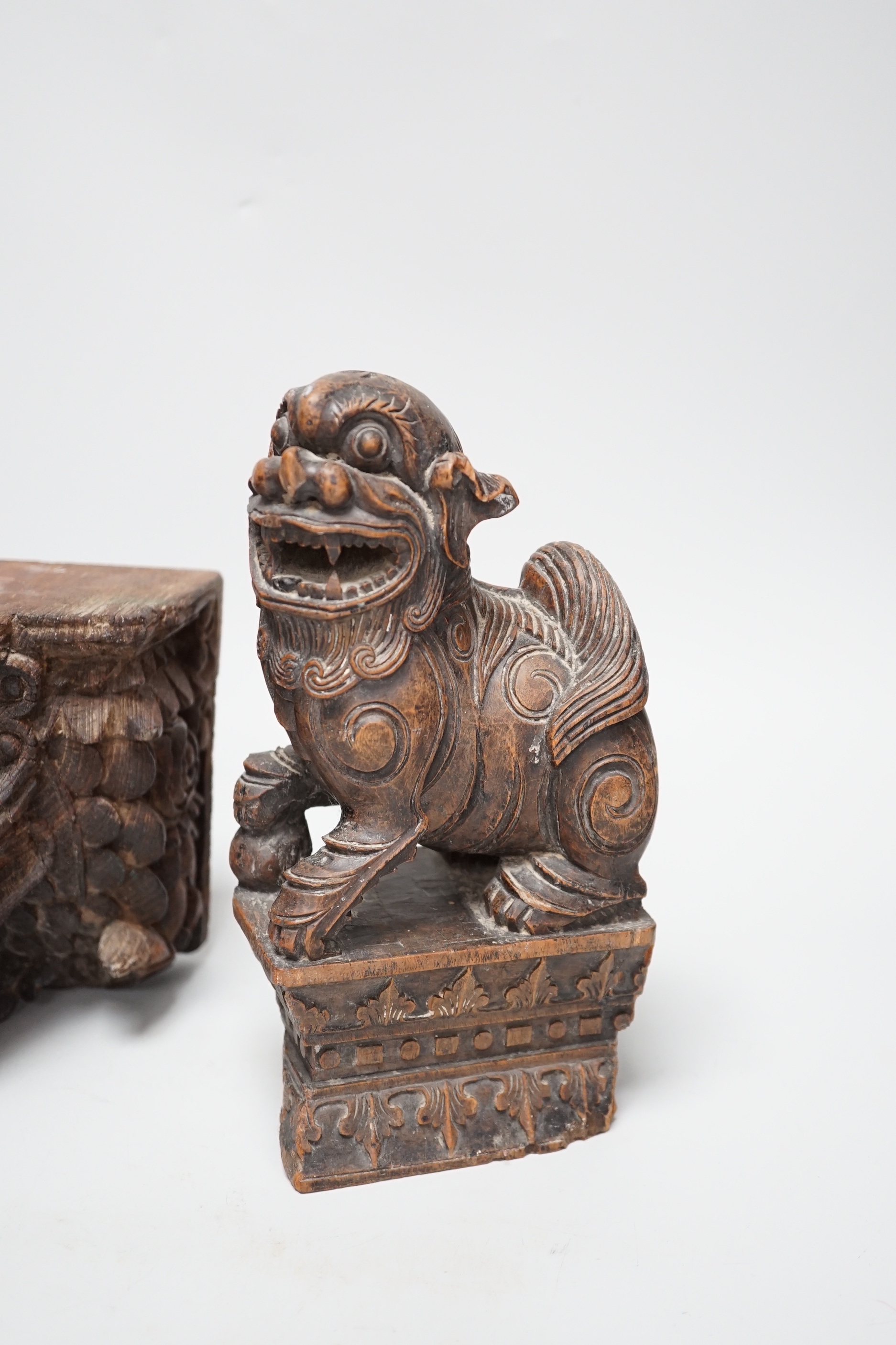 A carved Chinese hardwood temple lion and wall bracket (2) tallest 23cm